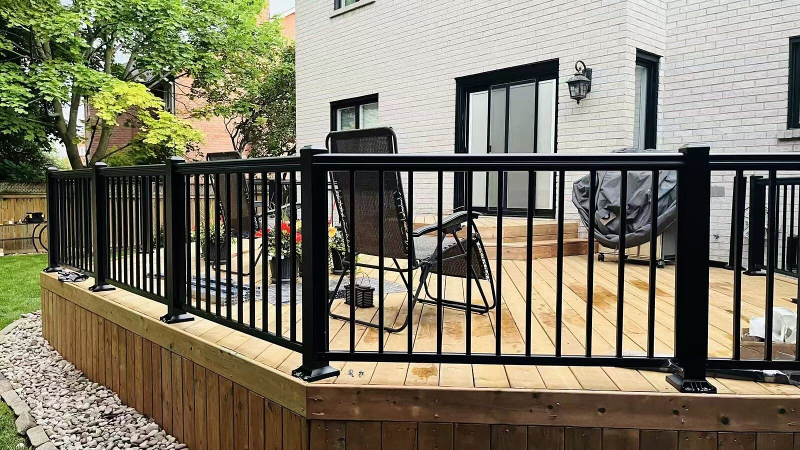 Composite deck finished with a frameless tempered-glass railing