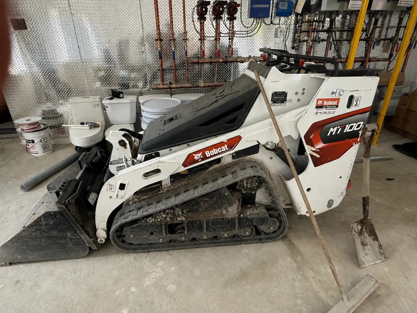 Bobcat MT100 mini track loader with a bucket attachment