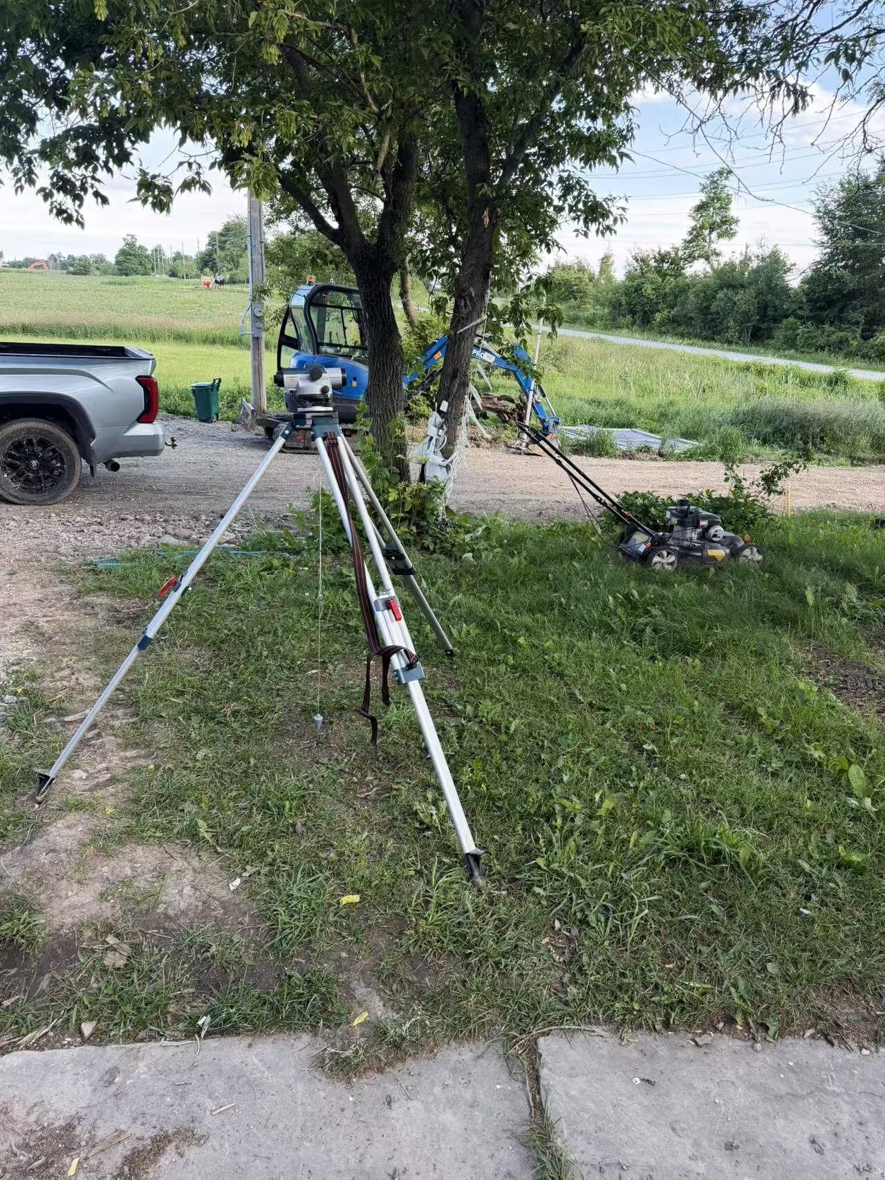 Laser layout and grading tripods set up on a job site
