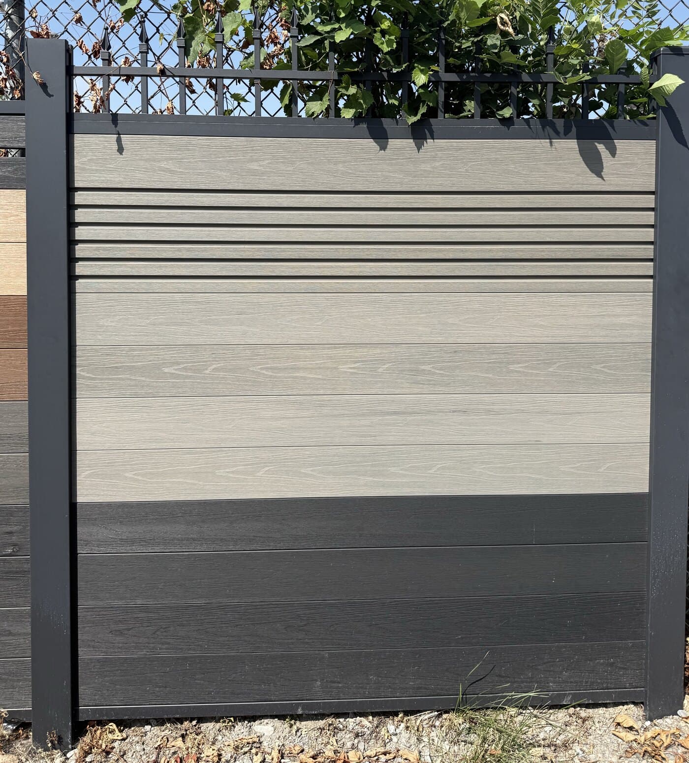 Two-tone grey WPC fence display panel with charcoal frame