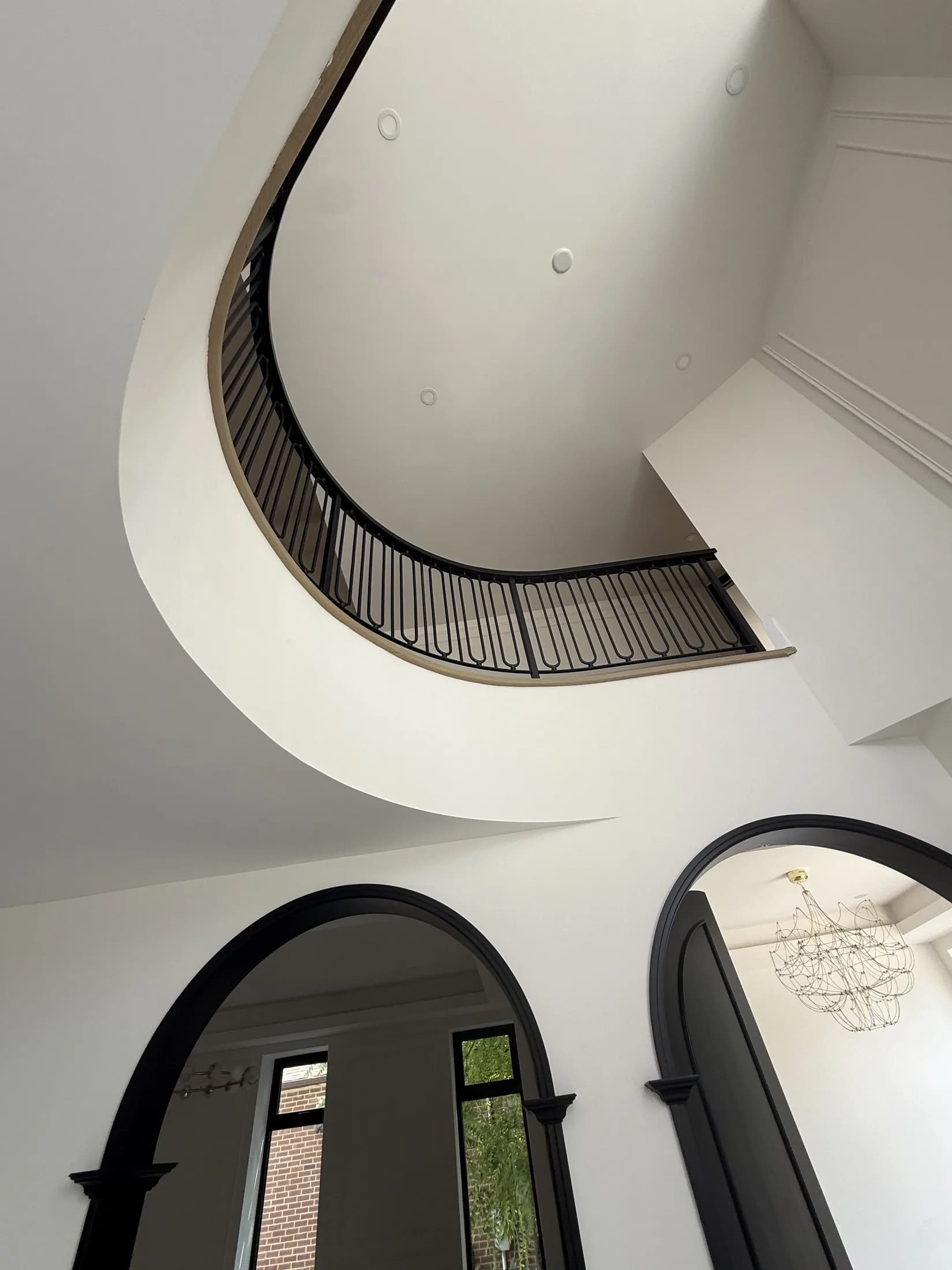 Custom decorative metal railing following a curved interior balcony